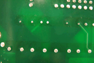 Figure 1: Dark stripes on the solder mask after selective soldering