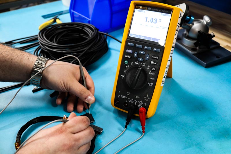 Multimeter Testing a Cable Assembly